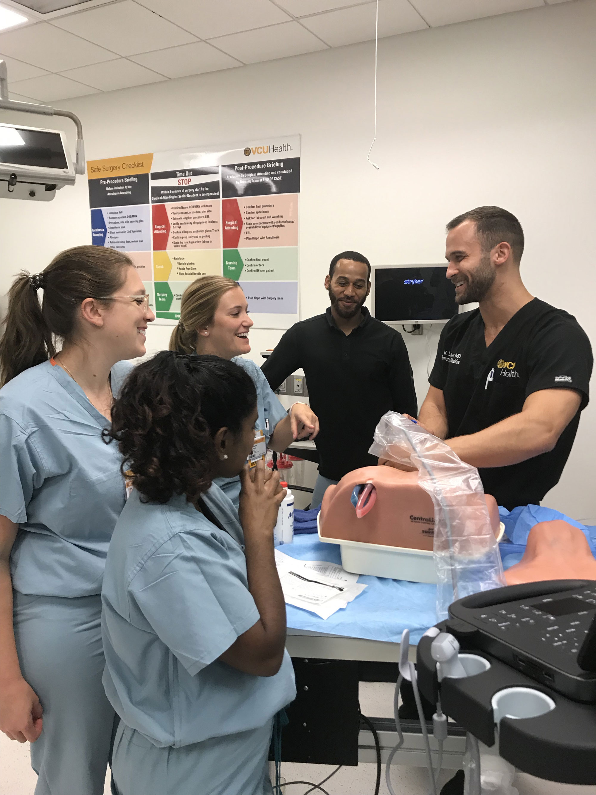 Man demonstrating medical equipment to others